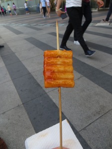 Ddeokbokki (spicy rice cakes) on a stick. Purchased for about 1 dollar. mmmm